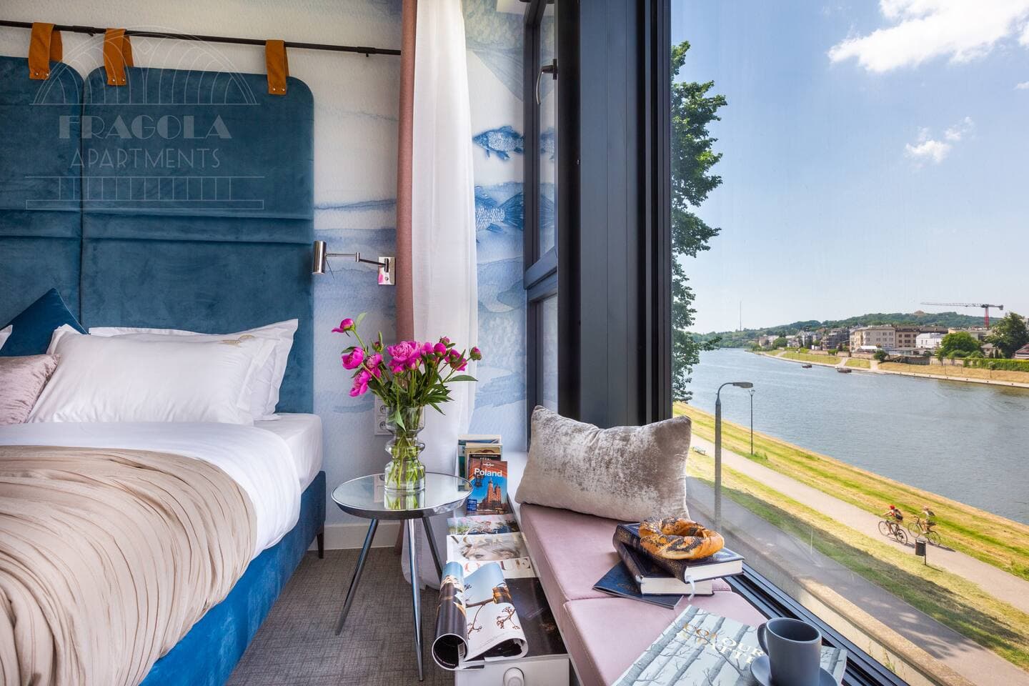 Enjoy a bedroom with a picturesque view overlooking the charming River Vistula, offering a serene backdrop that enhances your stay with natural beauty.