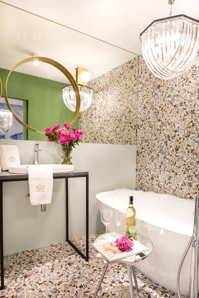 Enjoy a luxurious bath in our elegant bathtub, illuminated by soft, ambient lighting and complemented by a stylish mirror, creating the perfect atmosphere for relaxation and pampering.