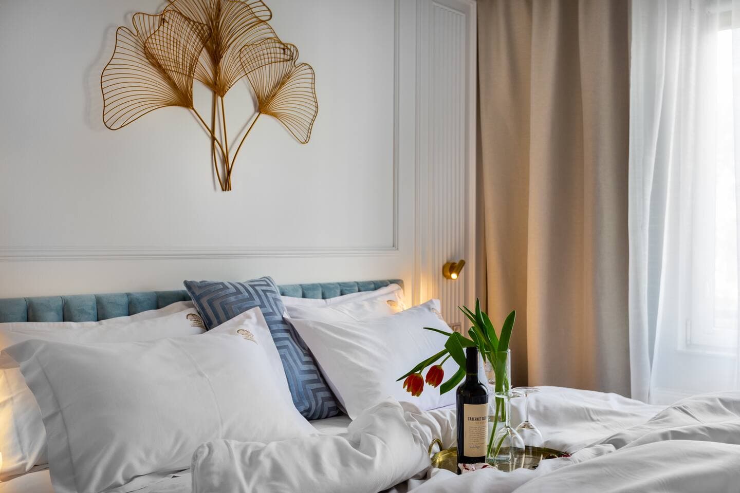Soft neutral bedroom w/ cozy bedding, warm lighting & calming decor touches
